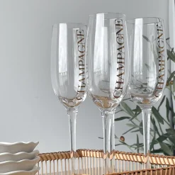 Hot Champagneglass, transparent/gull Borddekking